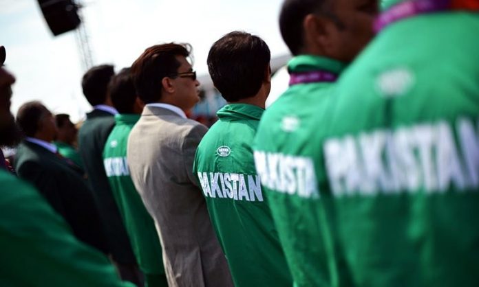 Pakistani athletes listen to the Olympic