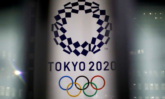FILE PHOTO: The logo of Tokyo 2020 Olympic Games is seen through signboards, in Tokyo